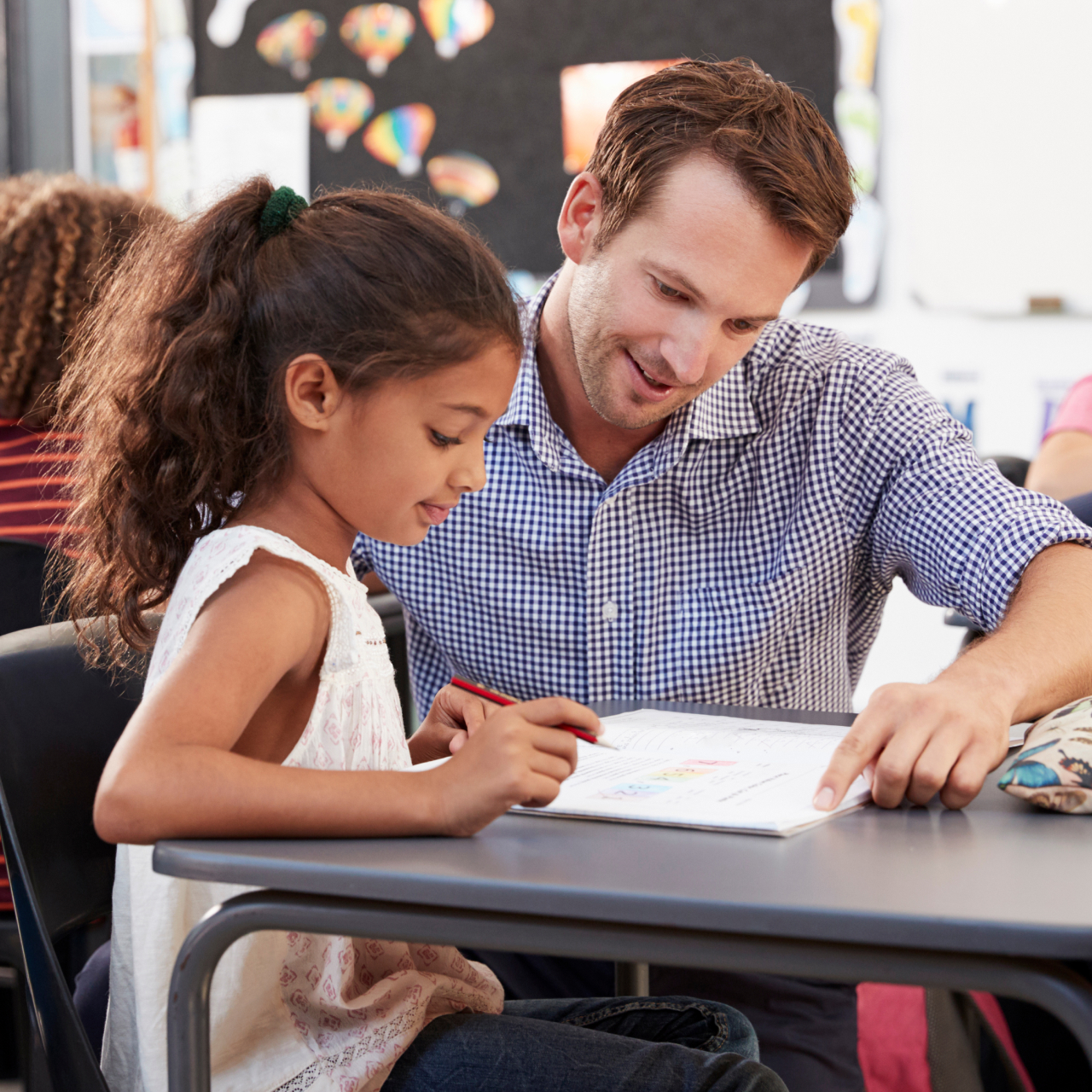 Enseignant aidant un jeune élève